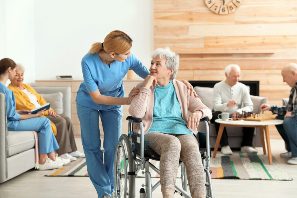 Nurses assisting elderly people at a retirement home