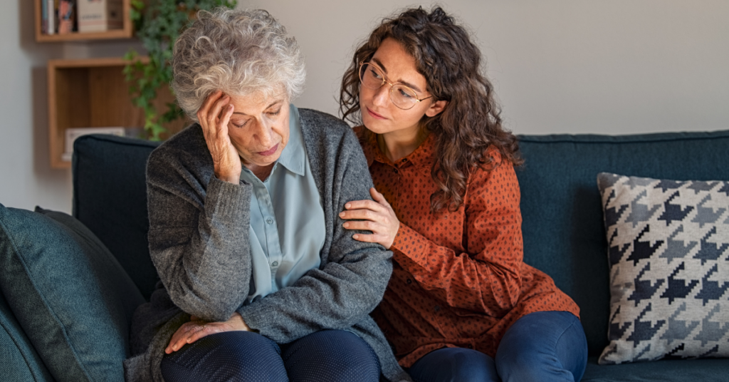 Young woman consoling elderly loved one